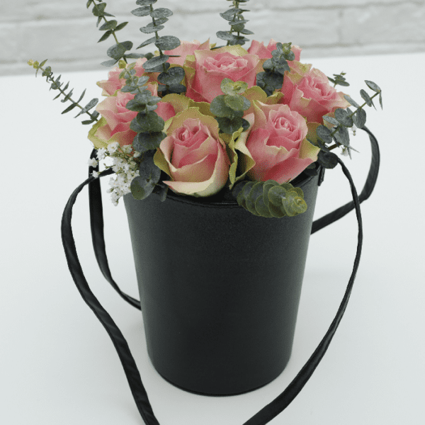 light pink rose in a velvet basket