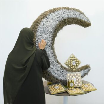 White and gold-themed Crescent-shaped flower arrangement with Ferrero chocolates for Eid