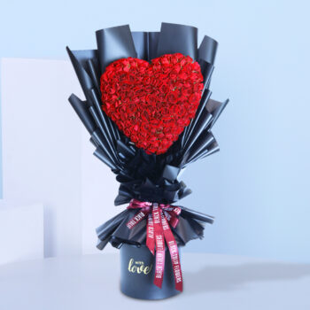 A bouquet of vibrant red roses arranged in a sleek black vase.