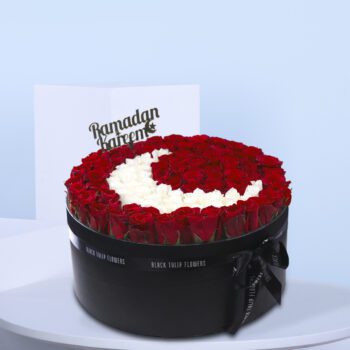 Luxurious black box with red and white roses in a crescent moon design.