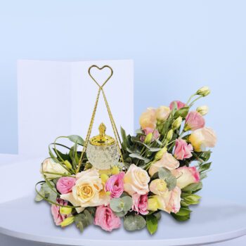 Pink and peach roses with a golden lantern, a beautiful Eid floral arrangement.
