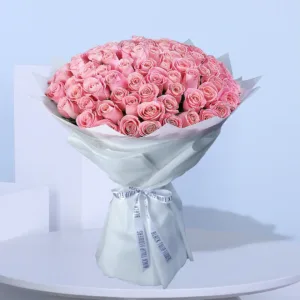 A breathtaking bouquet of numerous soft pink roses, tightly clustered together to form a voluminous and elegant arrangement