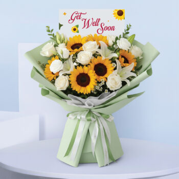 Bouquet featuring hand-tied sunflowers, white roses & lilies in pastel green wrap, finished with a “Get Well Soon” card.